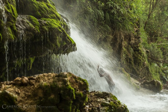 A Haitian bathes and prays in the waterfall of Saut d'Eau during the annual pilgrimage.