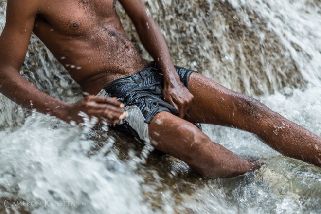 A pilgrim cleanses and scrubs himself of his sins in the waters of Saut d'Eau.