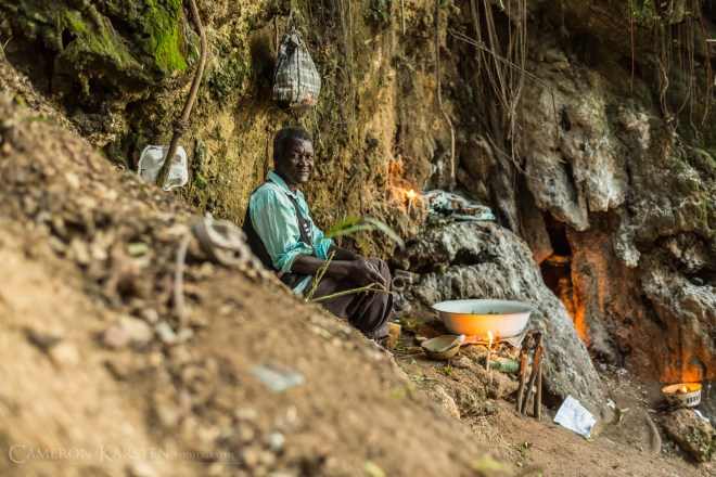 A man sells candles for pilgrims at the waterfalls of Saut d’Eau.