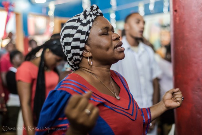 A vodouisant prepares to receive the spirit Ogue Feray, the warrior spirit whose main color is red.