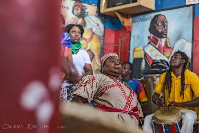 A vodouisant in attendance goes into trance as the congregation calls Les Mysteres from across the waters in Africa by the sound of the drums, the singing and pure merriment of the people. Vodou spirits are believed to have been mortals in past eras. By entering the body of a human, trance is the spirit's way of enjoying the pleasantries of humanity once again.