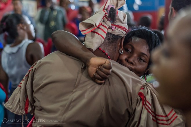 Two congregation members in trance embrace at a hounfour in Montagne Noire, Port-au-Prince.